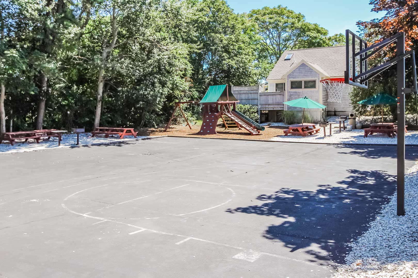 A spacious basketball court and playground at the Holly Tree Resort in Massachusetts.